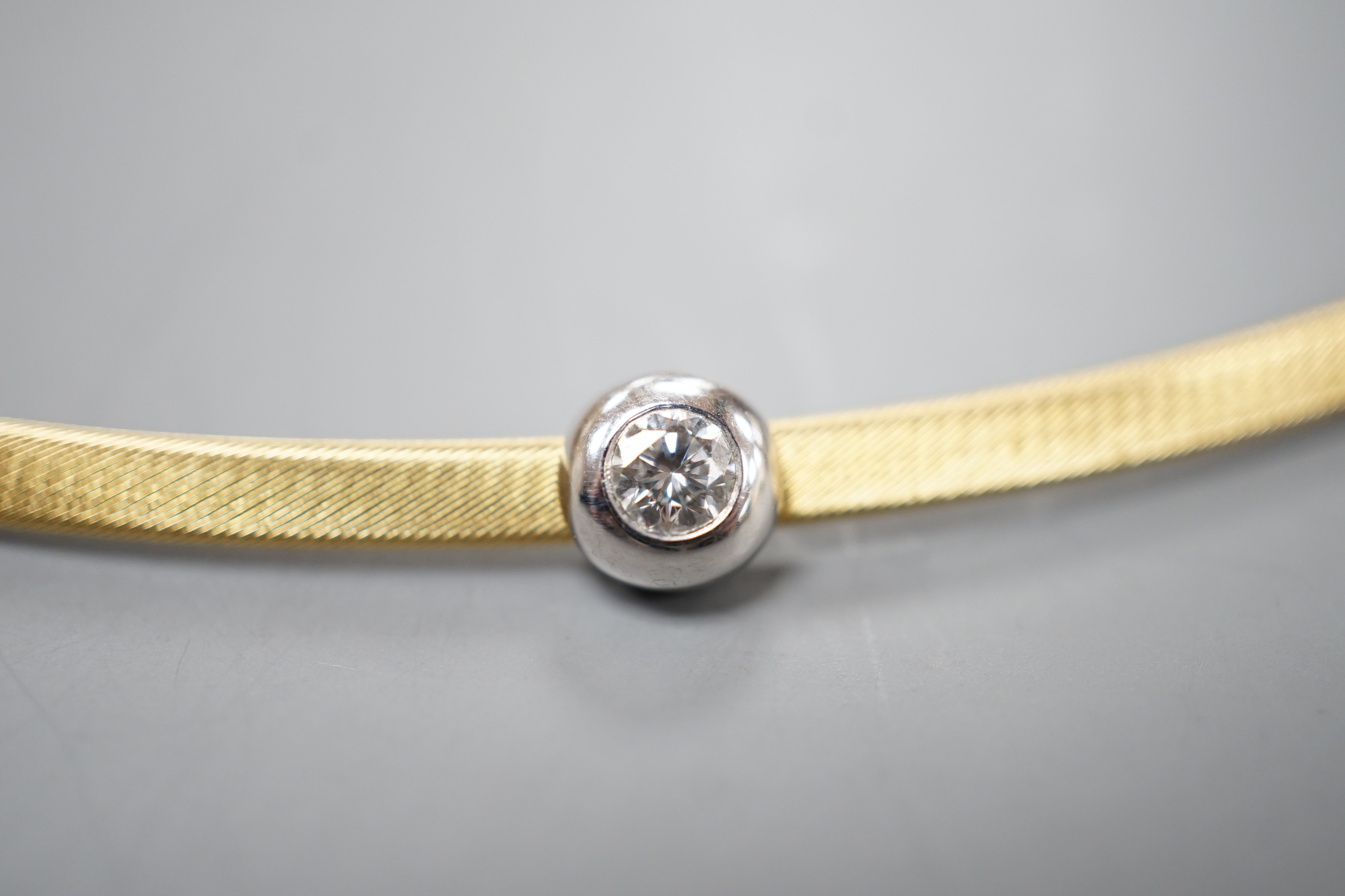A modern 750 yellow metal and solitaire diamond set necklet, approx. 34-36cm, gross weight 8.2 grams.